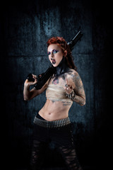 Young tattooed woman, one-eyed, rifle in his hands