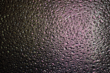 bokeh drop texture on glass background dark purple