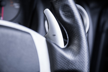 Silver paddle shifting on car steering wheel