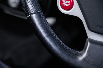 Close up of black leather steering wheel