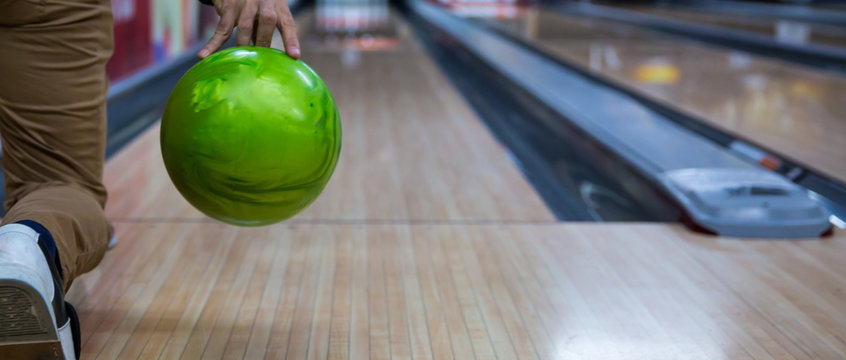 Man's hand holding a bowling ball ready to throw it
