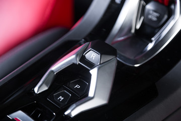 Fototapeta na wymiar Reverse transmission control in sports car interior
