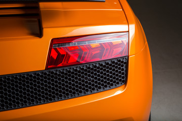 Rear brake light on orange sports car