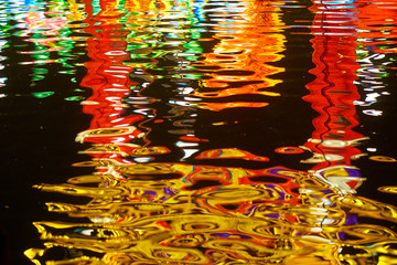 Colorful neon reflections in dark water.