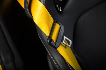 Close up of yellow car seat belt