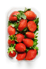 Plastic packaging of fresh juicy strawberries. Saturated colors. White isolated background. Top view.