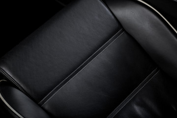 Close up of black leather car seat
