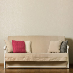 Beige sofa with colorful pillows (pink, grey, white) in the living room.