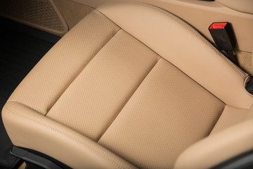 Detail shot of beige leather car seat of luxurious car