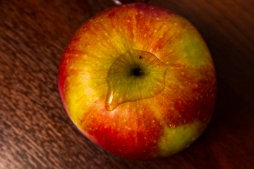 Healthy organic apple isolated on a dark wood background