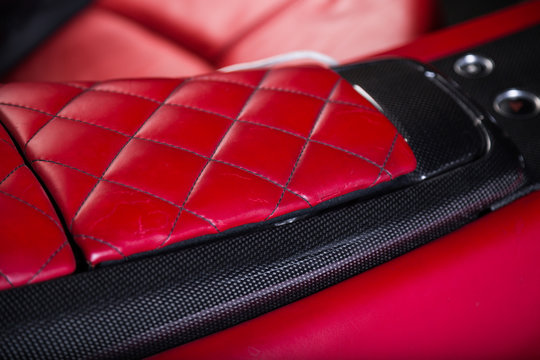 Close up of red leather arm rest of sports car