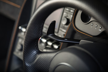 Fototapeta na wymiar Paddle shifting in sports car steering wheel