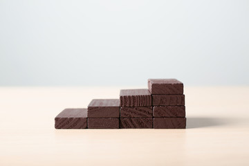 Stacked blocks on wooden table. Concept of career