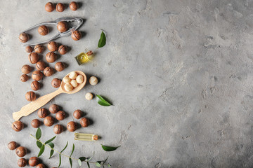 Macadamia nuts with oil on grey background