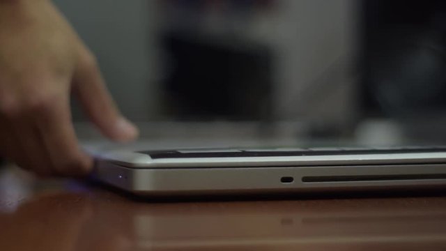 Hands open macbook on the table close up