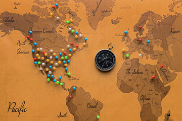 Compass with pins on world map