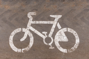 Bicycle lane sign on asphalt close up, background and texture
