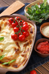 Tasty baked lasagna on table