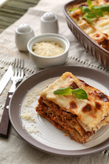 Tasty baked lasagna on table