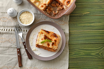 Tasty baked lasagna on wooden table