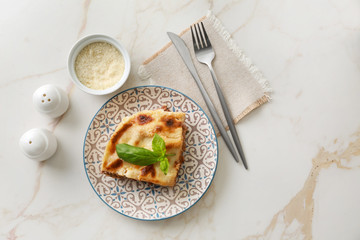 Tasty baked lasagna on light table