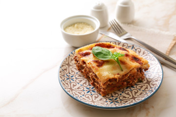 Tasty baked lasagna on light table