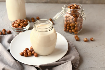 Jar of tasty hazelnut milk on table