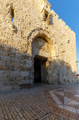 Zion gate in a wall of Jerusalem at sunset