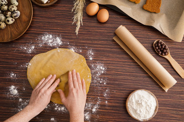 Woman cooking tasty Easter cookies on wooden table