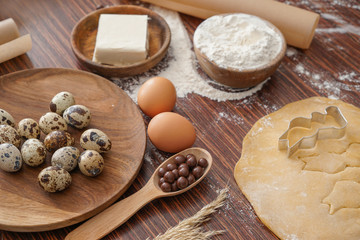 Fototapeta premium Cooking of tasty Easter cookies on wooden table