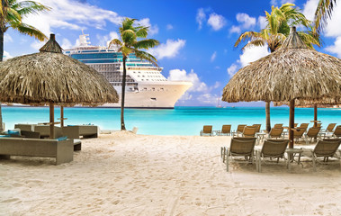 View from tropical beach on cruise ship sailing to port 