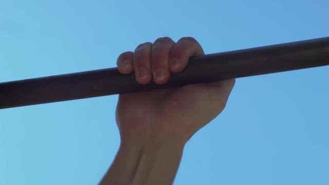 Close up of hand Pull Up Bar Training at Outdoor.