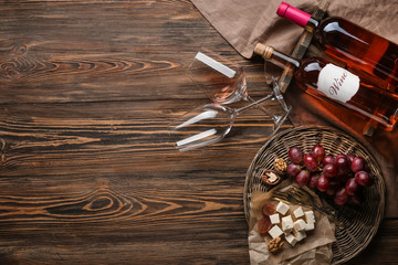 Composition with wine and snack on wooden background