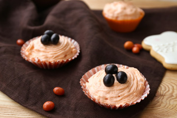Tasty Easter cupcakes on wooden table