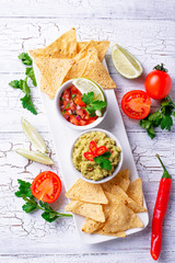 Guacamole, tomato sauce salsa and chips nachos