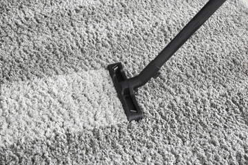 Brush of vacuum cleaner on carpet