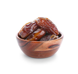 Bowl with tasty dried dates on white background