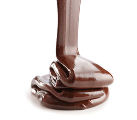 Pouring of melted chocolate on white background