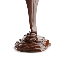 Pouring of melted chocolate on white background