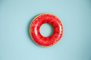 Bright inflatable ring on color background
