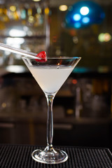 Expert barman is making cocktail at night club, Barman holds a cocktail in his hand. No face. Selective focus