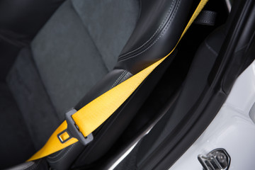 Yellow seat belt on black car seat