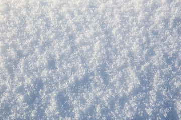 Melting clean white snow texsture closeup on spring sun. Cold background.