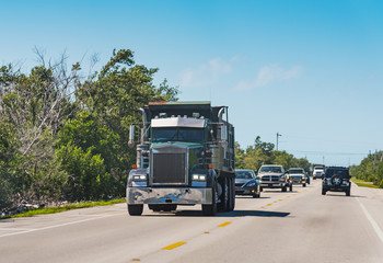 Fototapeta na wymiar Big truck and other vechicles on Overseas Highway in Florida Keys