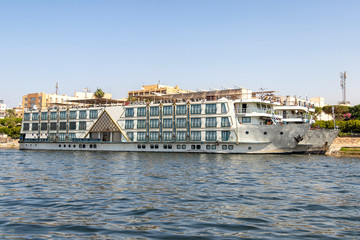 Naklejka premium Tourist boats moored on the Nile river at Luxor. The tourist boats cruise between Luxor and Aswan in Upper Egypt