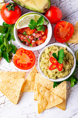 Guacamole, tomato sauce salsa and chips nachos