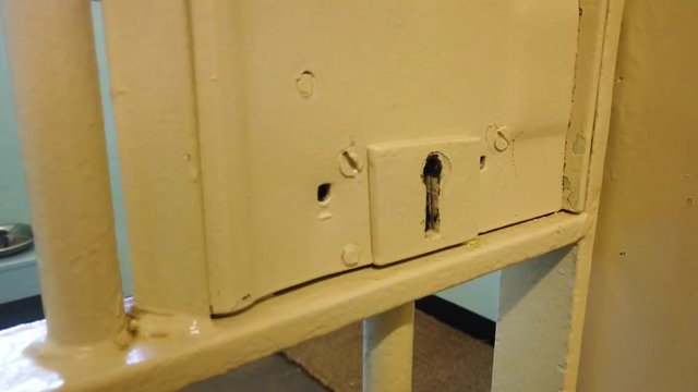Tracking into a closeup of a cell door lock at the prison on Robben Island.