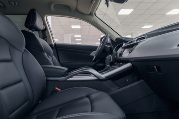 Leather car interior. Modern car illuminated dashboard. Luxurious car instrument cluster. Close up...