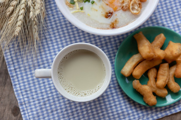 Breakfase meal. Congee or Rice porridge minced pork, boiled egg with soy milk and Chinese deep fried double dough stick