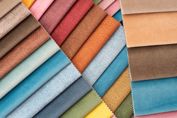 Colorful and bright curtains fabric pattern palette texture samples as abstract textile background. Handmade, clothes and furniture decoration concept. Scraps of colored tissue close up